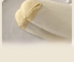 Detailed close-up showing flat toe seam craftsmanship on cream cotton slouch socks