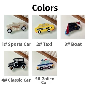 Detail of cartoon vehicle hair claws showing taxi, police car and ship designs