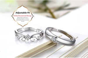 Macro view showing the silver adjustable opening design on the couple's ring set