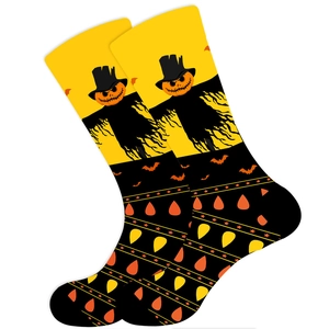 Close-up of Halloween mid-calf socks featuring pumpkin and bat prints on white background