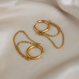 Elegant 18K gold plated stainless steel double chain hoop earrings on silk background
