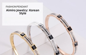 Three minimalist titanium steel bangles in gold, silver, and rose gold with black stones