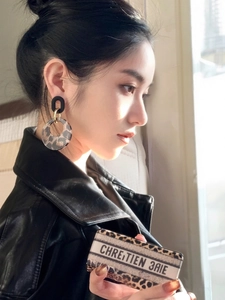 Detail of leopard print resin hoop earrings with retro geometric design for women