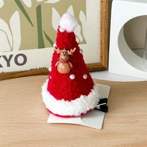 Detail of red plush Christmas hat hair clip with deer charm and pearl accents