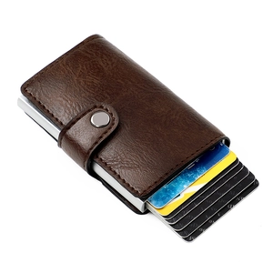 Macro shot of dark brown lychee leather RFID blocking card holder with aluminum pop-up slot