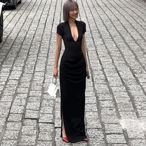 Detail of elegant black deep V-neck maxi dress with waist ruching and side split
