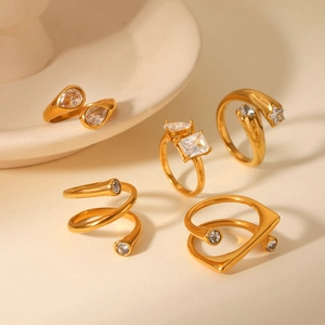 Detail view of 18K gold plated stainless steel rings set with zircon stones and star shapes