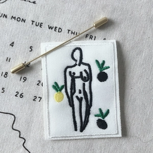 Artistic chic embroidery patch and gold pin featuring a minimalist female body sketch