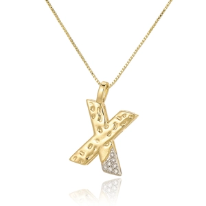 Detailed close-up of gold-tone letter X pendant with textured finish and cubic zirconia