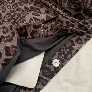Interior view of leopard print tote bag with silver magnetic closure and laptop storage