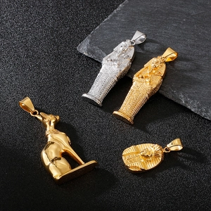 Macro view of ancient Egyptian Pharaoh and Bastet cat pendants in gold and silver finish