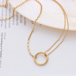 Double-layered 18k gold plated necklace with ring pendant on elegant seashell tray