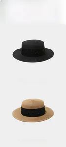 Detail of woven straw boater hats with elegant rhinestone-studded black tulle ribbons