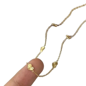 Minimalist gold heart necklace with radial laser texture on dainty steel chain