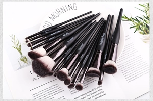 Detail of 15 professional makeup brushes with mermaid handles on white background