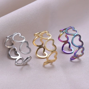 Detail of interlocking hollow heart rings in gold, silver, and iridescent finishes