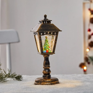 Vintage bronze Christmas lantern with miniature tree and sparkling snow inside