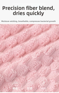 Macro shot of pink microfiber bath towel featuring a soft wavy embossed texture