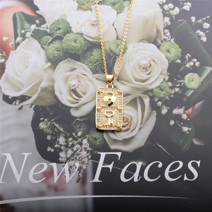 Macro shot of gold heart lock and key pendant necklace with sparkling gemstones