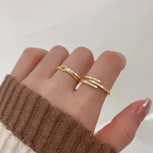 Detail of two gold pave zircon rings showing intricate diamond settings and metal texture