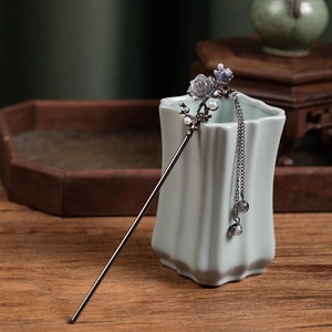 Detail view of retro chinese hair stick with rose petals, pearls and long chain tassels