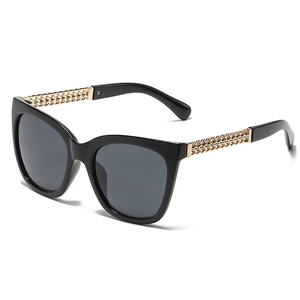 Retro oversized cat eye sunglasses with black frame and golden chain temples