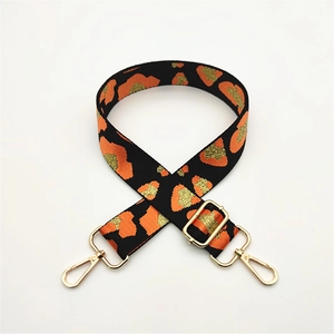 Adjustable leopard print bag strap with gold threads and metallic swivel hooks