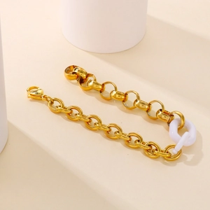 Retro gold chunky chain bracelet with white resin ring link on minimalist white display