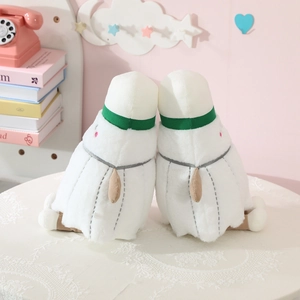 Cute white badminton bird plush dolls on a lace table with cozy pink home decor