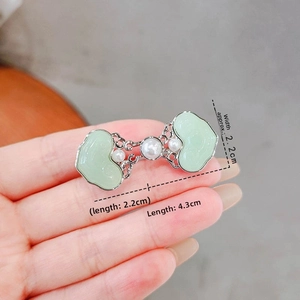 Detail showing Ruyi jade-like buckles with pearls and silver filigree including size measurement