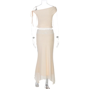 Detail of apricot two-piece set featuring lace waist trim and chiffon skirt texture
