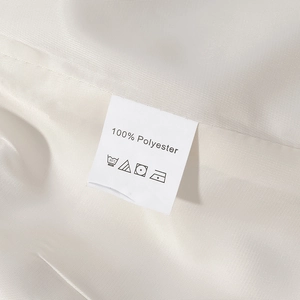 Close-up detail of the 100% polyester fabric lining and care label on this long coat