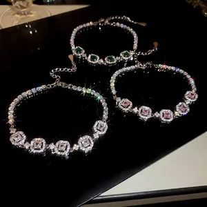 French court style emerald and diamond geometric bracelet on a black mirror background