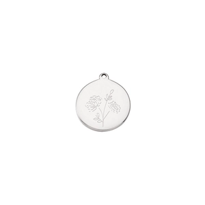 Detail of silver stainless steel round pendant with engraved flower pattern and hanging loop