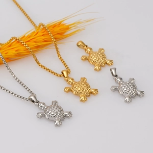 Minimalist 18K gold and silver turtle pendant necklace on a clean white background