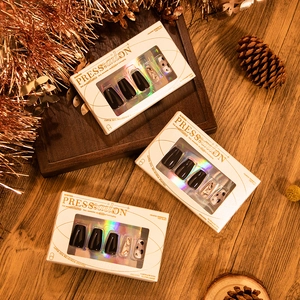 30-piece press-on nail set in deep brown and gold glitter with festive gift packaging