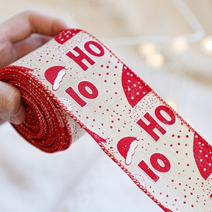 Christmas burlap ribbon with red and white HO HO prints and festive Santa hat patterns