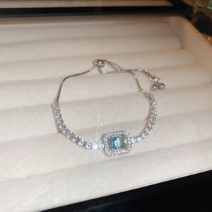 Exquisite silver tennis bracelet with a rectangular blue zircon centerpiece and slider clasp