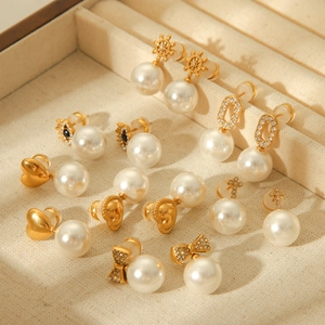 Collection of vintage French style pearl earrings with gold bow and heart designs