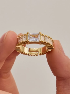 Macro shot of gold-plated adjustable ring featuring rectangular zircon and side baguette stones