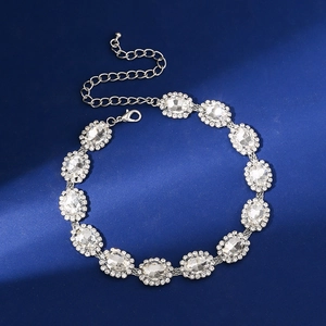 Detail of crystal choker necklace with oval rhinestones and lobster clasp on blue background