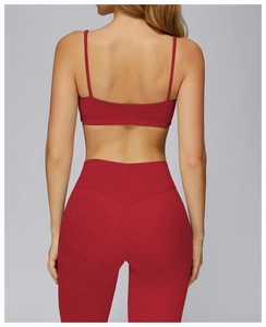 Detail view of red brushed yoga set featuring cross-back sports bra and high-waist leggings