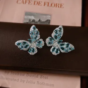 Exquisite silver butterfly stud earrings with blue zirconia on a luxury leather box