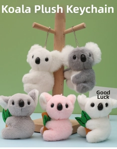 Detailed shot of cute plush koala keychains in white, grey, and pink with metal chains