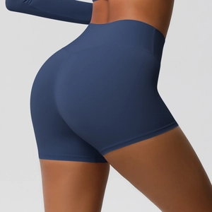 Detail view of high waisted navy yoga shorts with moisture wicking fabric and lifting effect