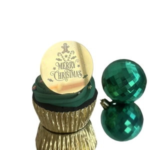 Golden acrylic Merry Christmas cupcake topper with gingerbread man on green frosting