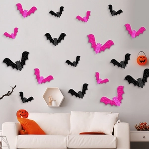 Pink and black glitter bat wall stickers arranged on a living room wall for Halloween decor