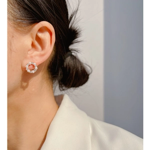 Mini pearl and zircon wreath stud earrings in champagne gold shown on a model