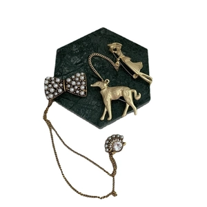 Baroque style gold-finish bow, dog, and figure brooches with pearls and chains