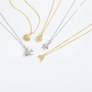 Detailed view of sea shell, turtle and dolphin pendants with subtle rhinestone inlay